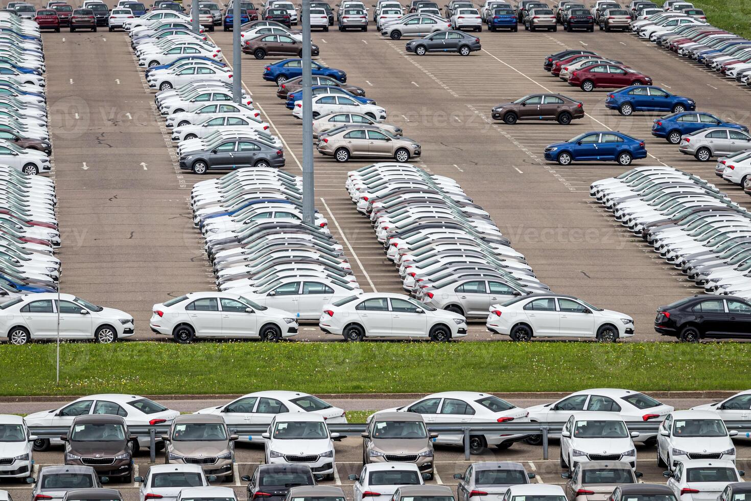 Volkswagen Group Rus, Russia, Kaluga - MAY 24, 2020 Rows of a new cars parked in a distribution center. Top view to the parking in the open air. photo