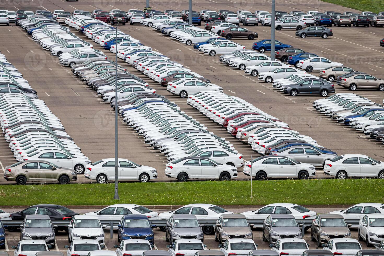 Volkswagen Group Rus, Russia, Kaluga - MAY 24, 2020 Rows of a new cars parked in a distribution center. Top view to the parking in the open air. photo
