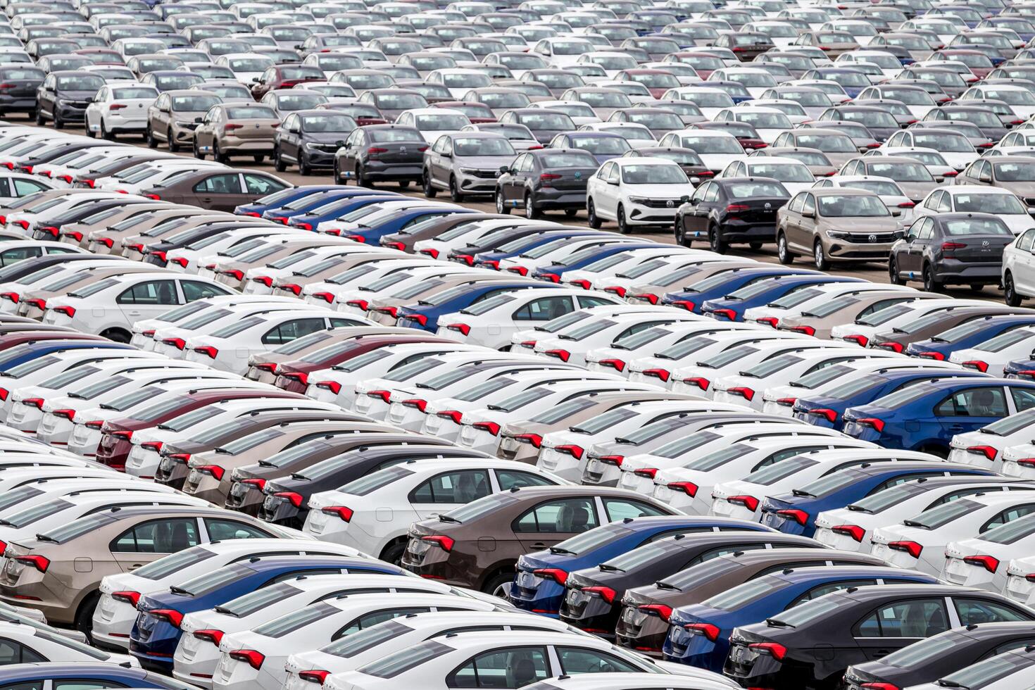 Volkswagen Group Rus, Russia, Kaluga - MAY 24, 2020 Rows of a new cars parked in a distribution center. Top view to the parking in the open air. photo