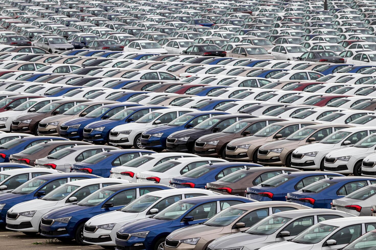 Volkswagen Group Rus, Russia, Kaluga - MAY 24, 2020 Rows of a new cars parked in a distribution center. Top view to the parking in the open air. photo