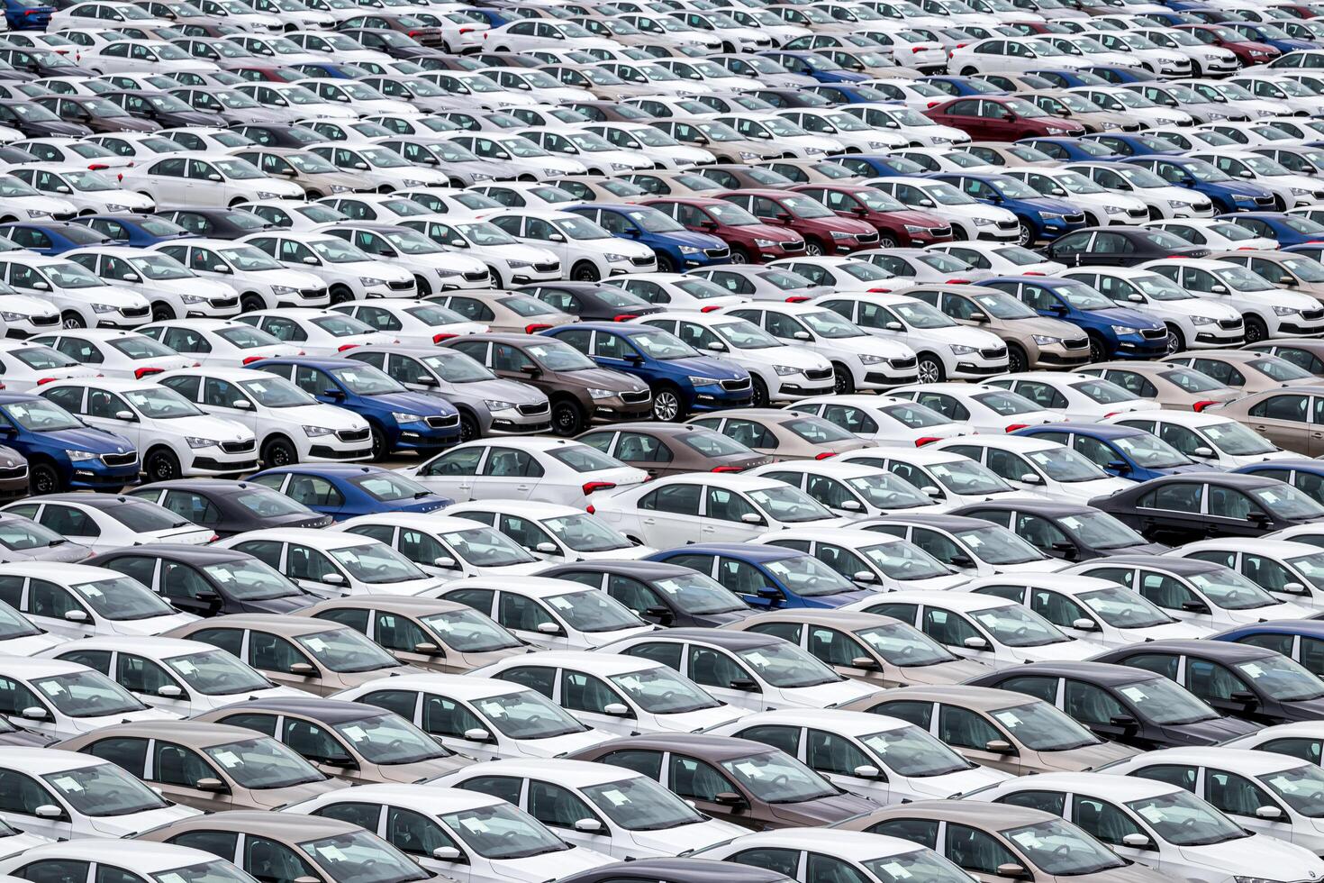 Volkswagen Group Rus, Russia, Kaluga - MAY 24, 2020 Rows of a new cars parked in a distribution center on a cloudy day in the spring, a car factory. Parking in the open air. photo