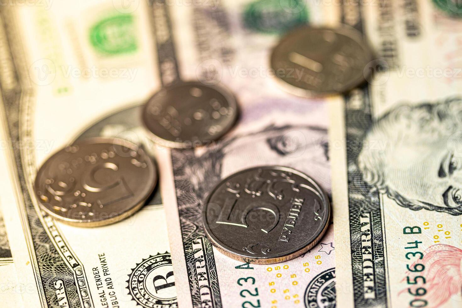 Five-ruble coin on the background of dollar bills. photo