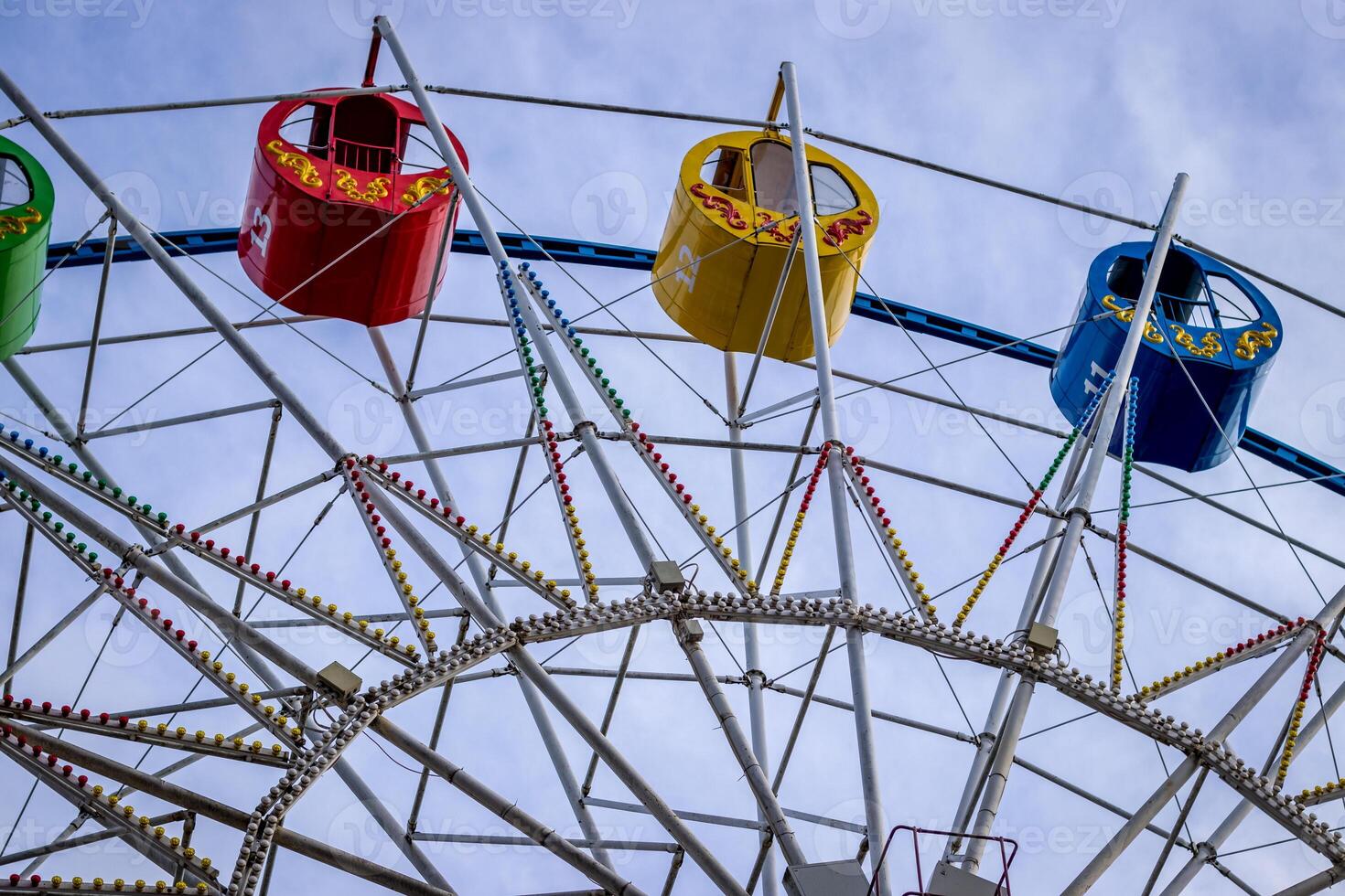 Ferris wheel with colorful cabs against the sky. photo