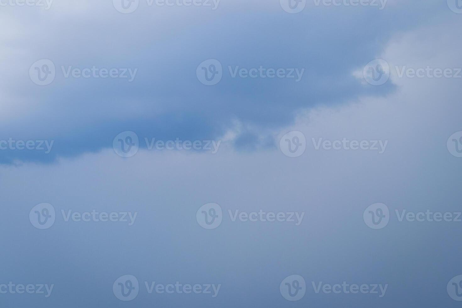 Dark blue heavy storm clouds before a thunderstorm or hurricane. Dramatic clouds in overcast weather. photo