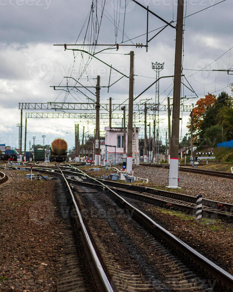 Railway with freight wagons and cisserines on it. photo