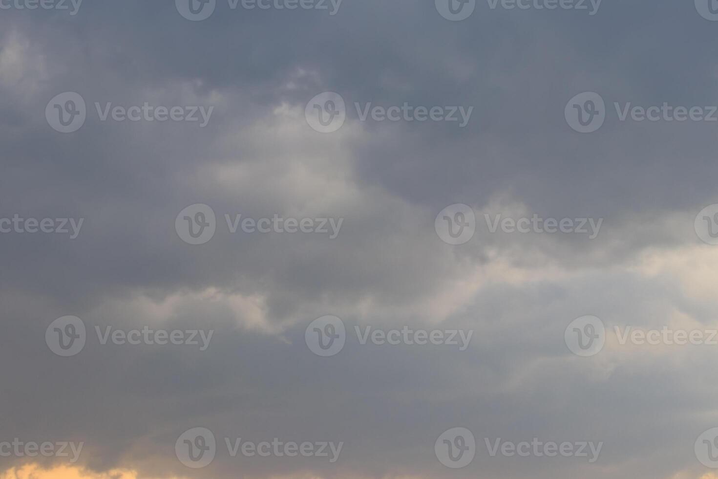 Dark blue heavy storm clouds before a thunderstorm or hurricane. Dramatic clouds in overcast weather. photo