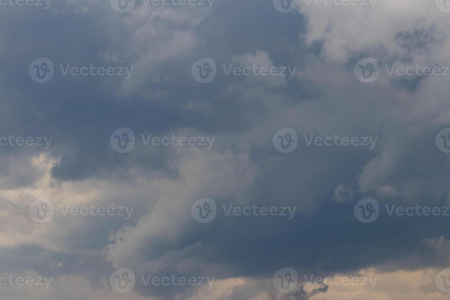 Dark blue heavy storm clouds before a thunderstorm or hurricane. Dramatic clouds in overcast weather. photo