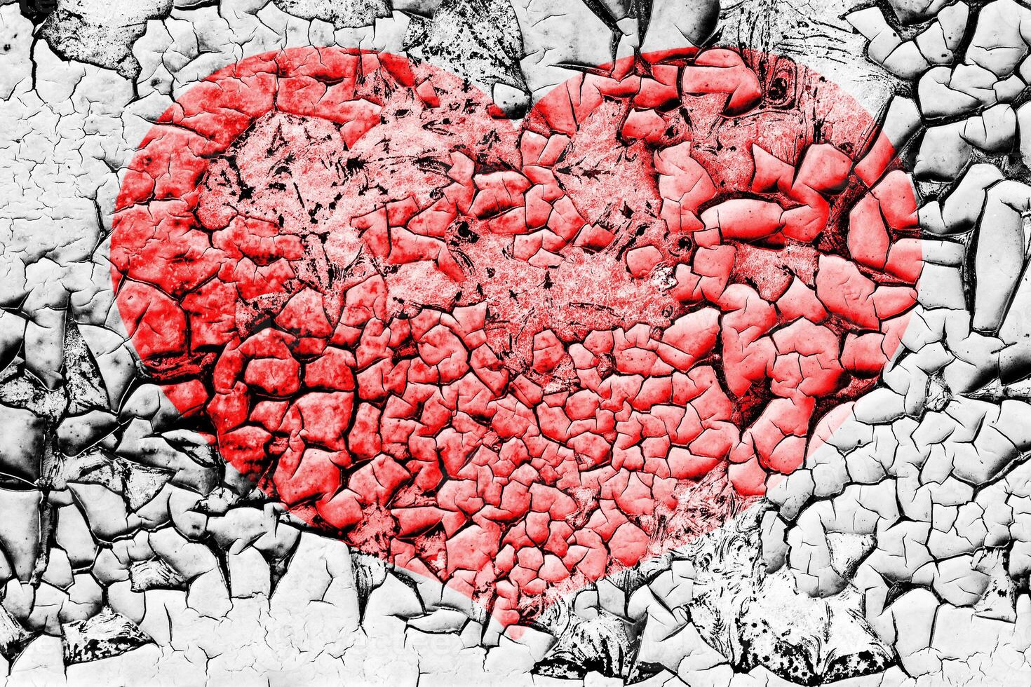 Red heart on a cracked texture. The concept of broken heart and the end of love. photo