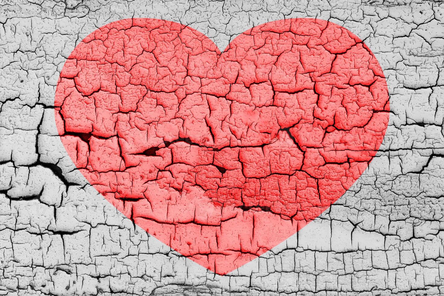Red heart on a cracked texture. The concept of broken heart and the end of love. photo