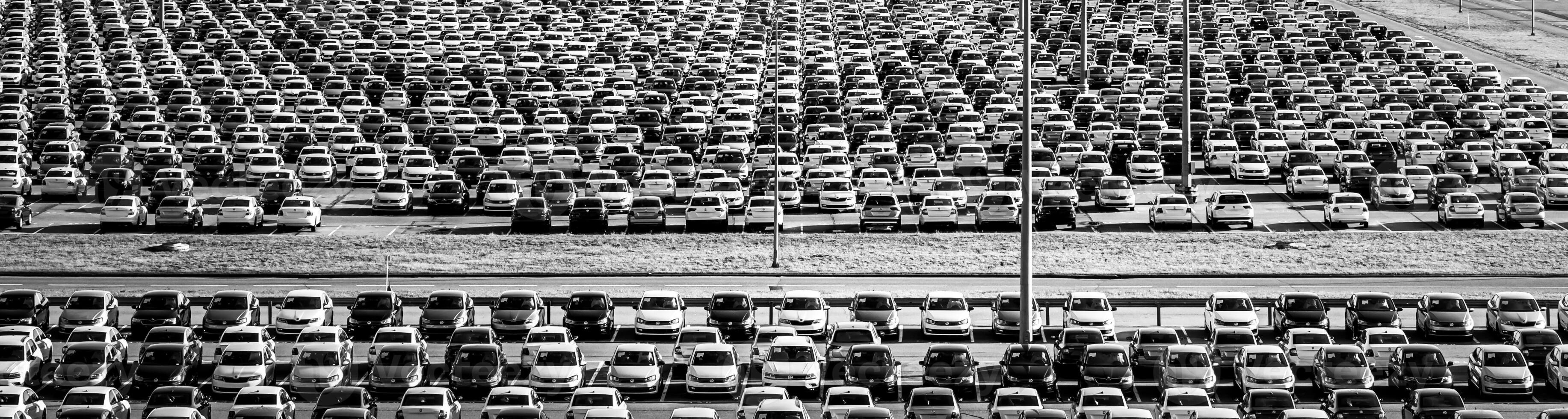 Russia, Kaluga - NOVEMBER 12, 2020 Rows of new cars parked in a factory or dealership parking lot. Black and white photo. photo
