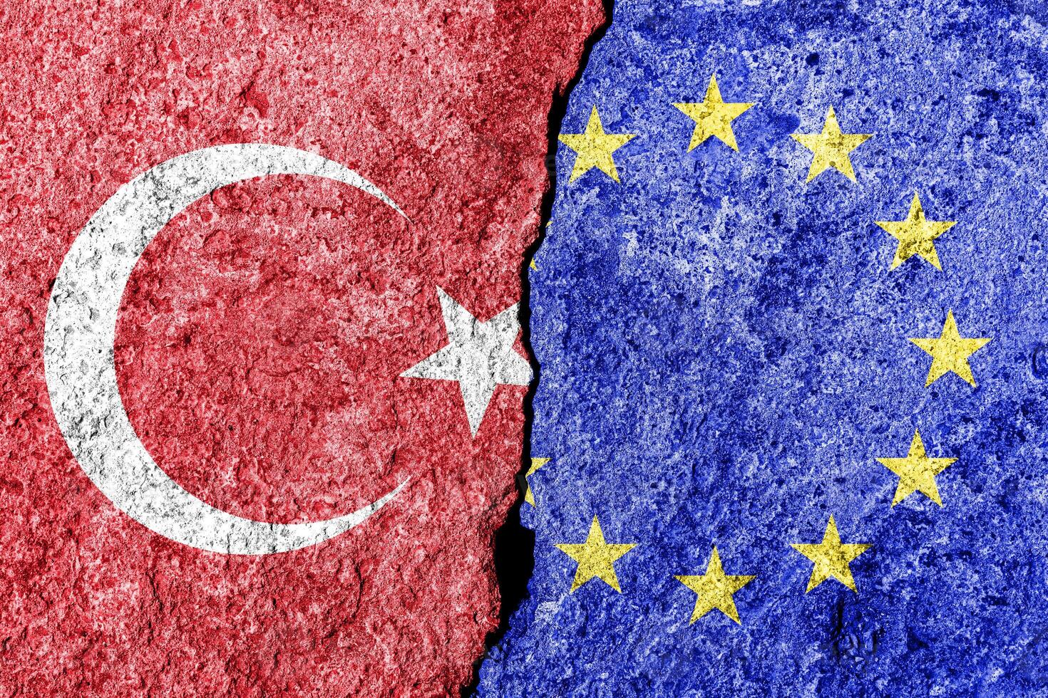 The crack between the European Union and Turkish flags on the concrete wall. The concept of sanctions, relationship problems and ban on tourism. photo