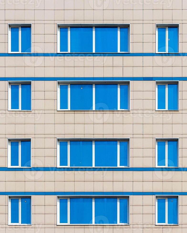 Fragment of an office building with blue mirrored windows. photo