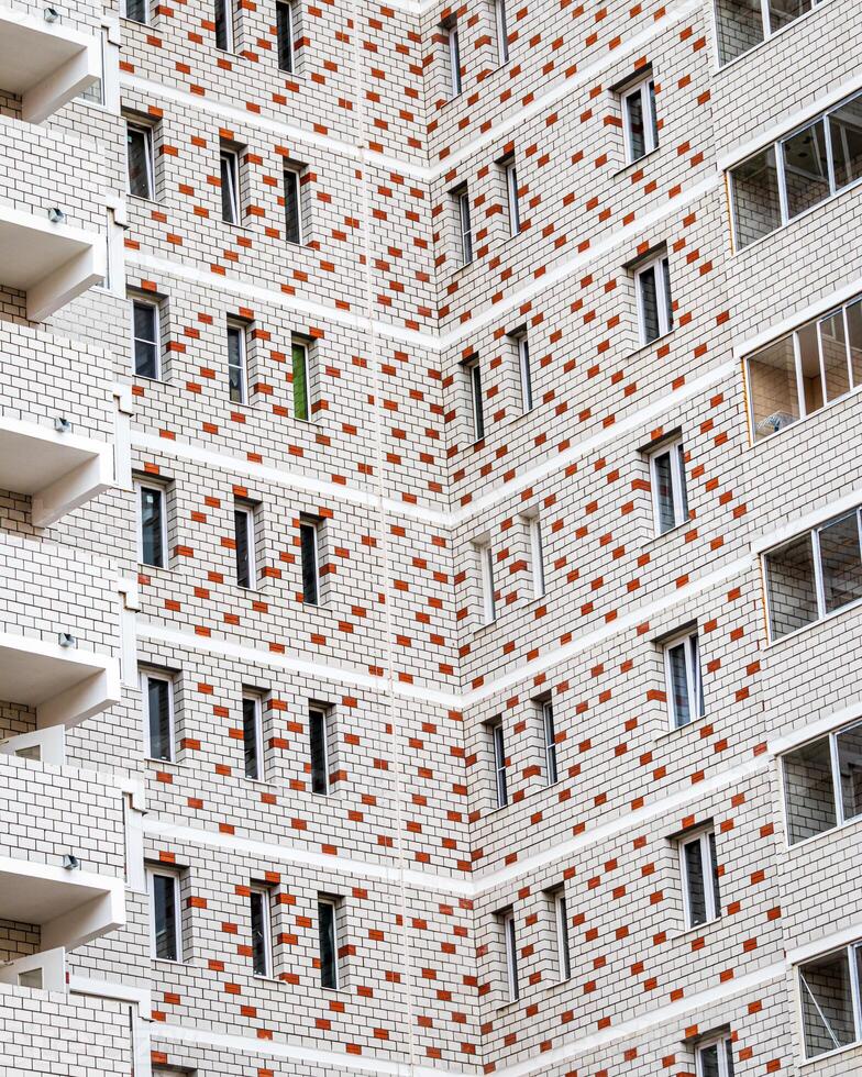 Fragment of the brick residential building with balconies. photo