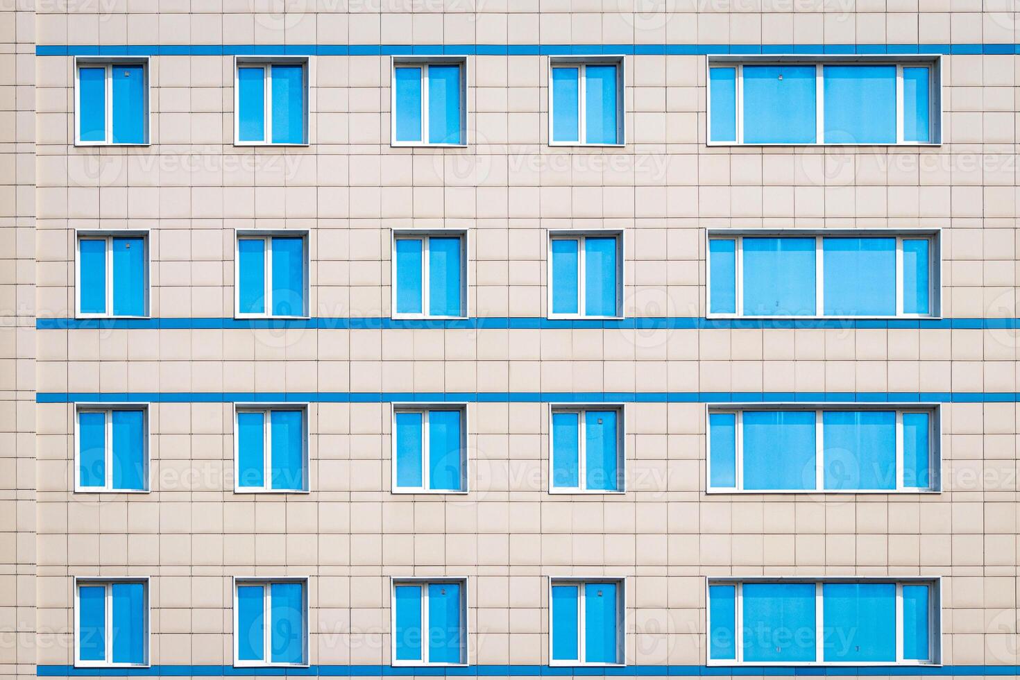 Fragment of an office building with blue mirrored windows. photo