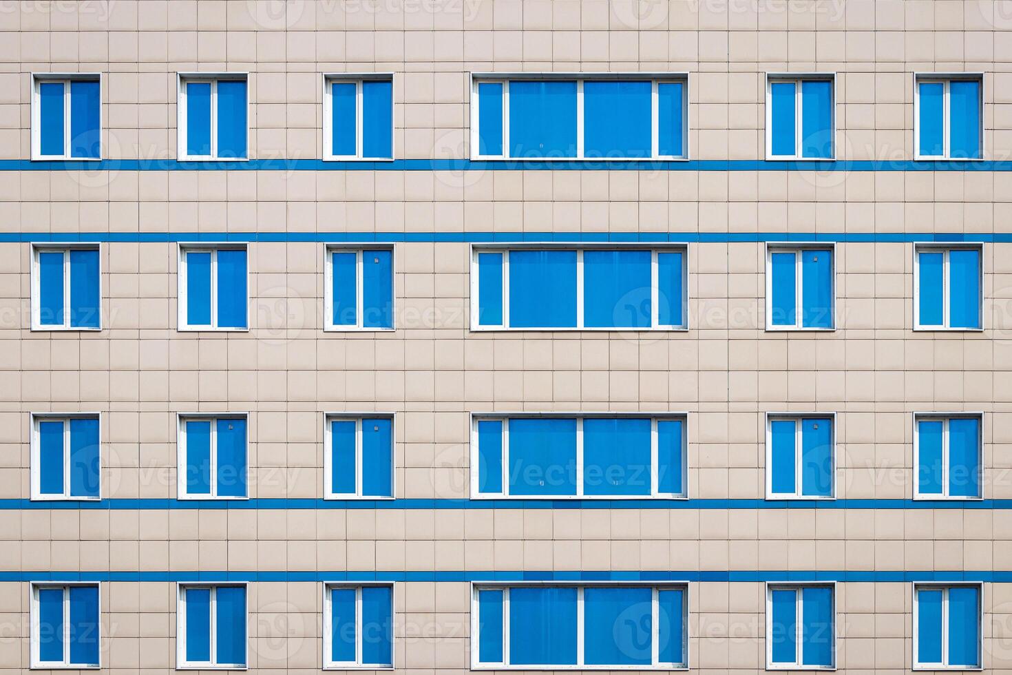 Fragment of an office building with blue mirrored windows. photo