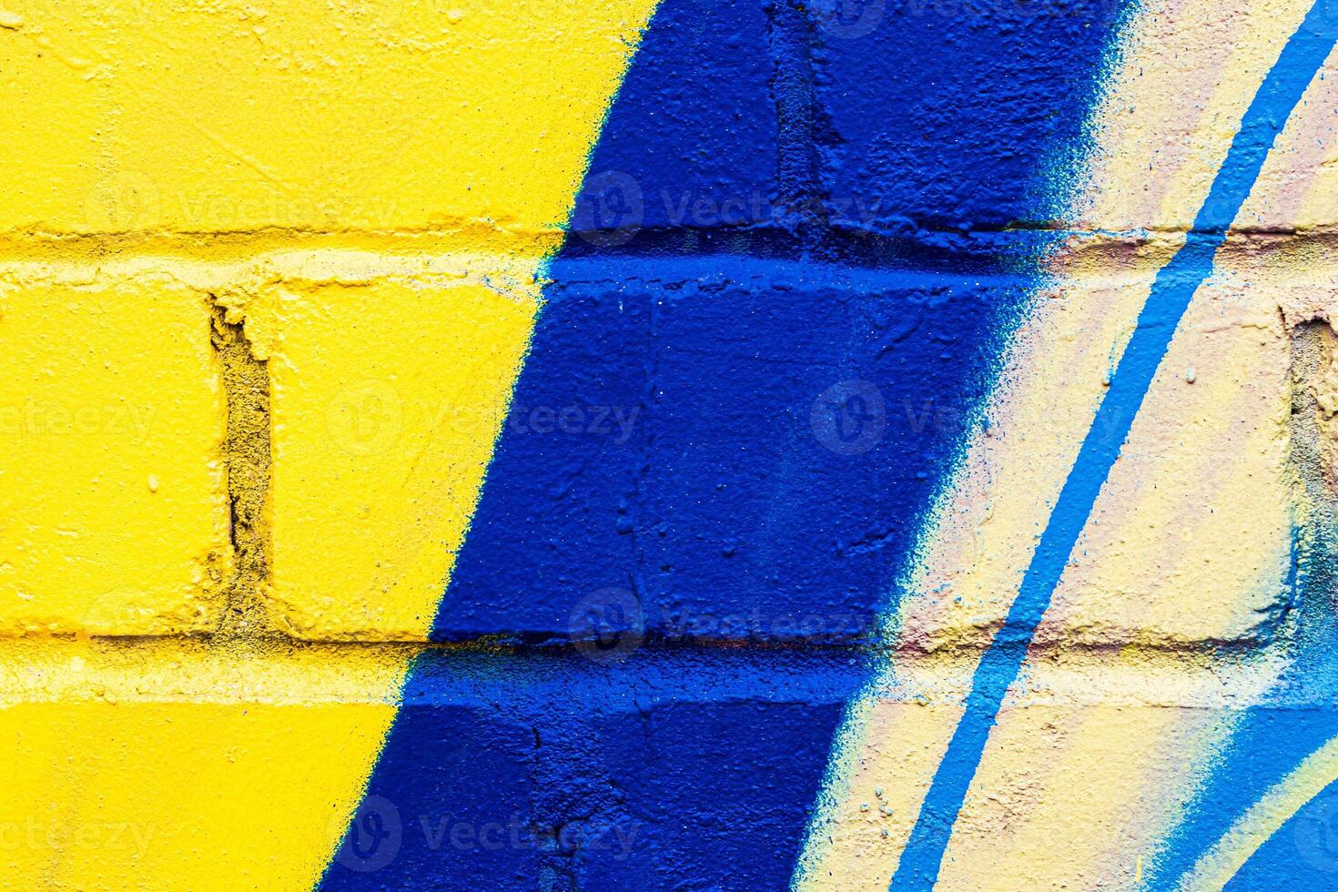 A fragment of colorful graffiti painted on a brick wall. Abstract backdrop for design. photo