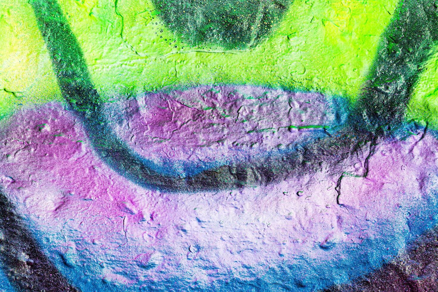 A fragment of colorful graffiti painted on a concrete wall. Abstract urban backdrop for design. photo