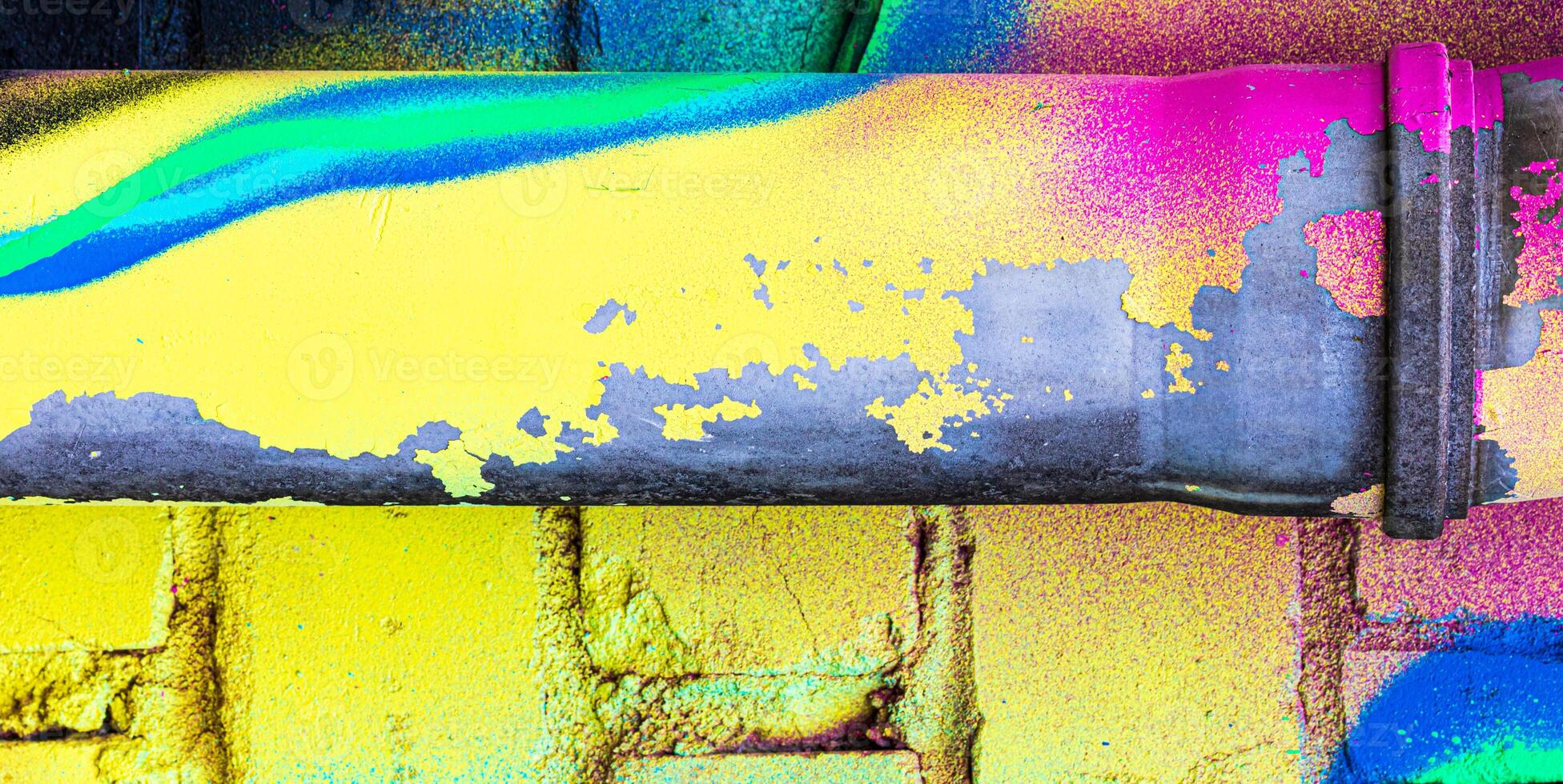 A fragment of colorful graffiti painted on a brick wall. Abstract backdrop for design. photo