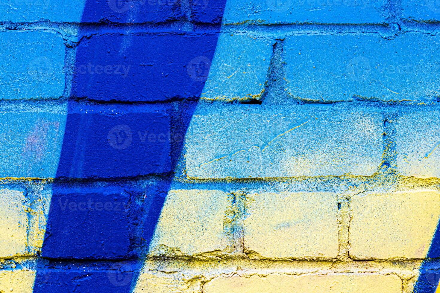 A fragment of colorful graffiti painted on a brick wall. Abstract backdrop for design. photo