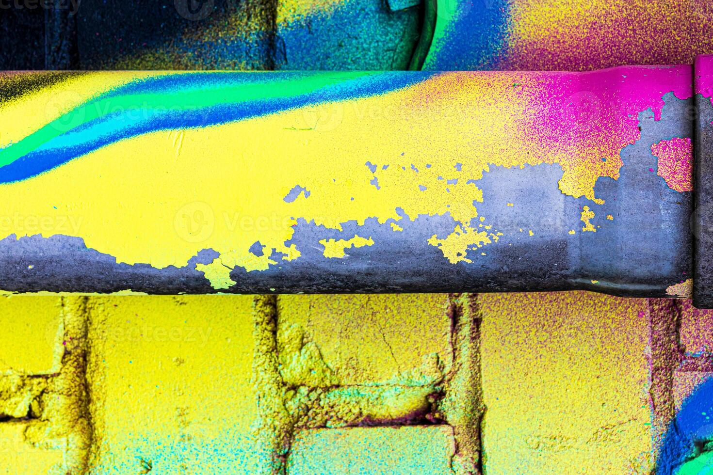 A fragment of colorful graffiti painted on a brick wall. Abstract backdrop for design. photo