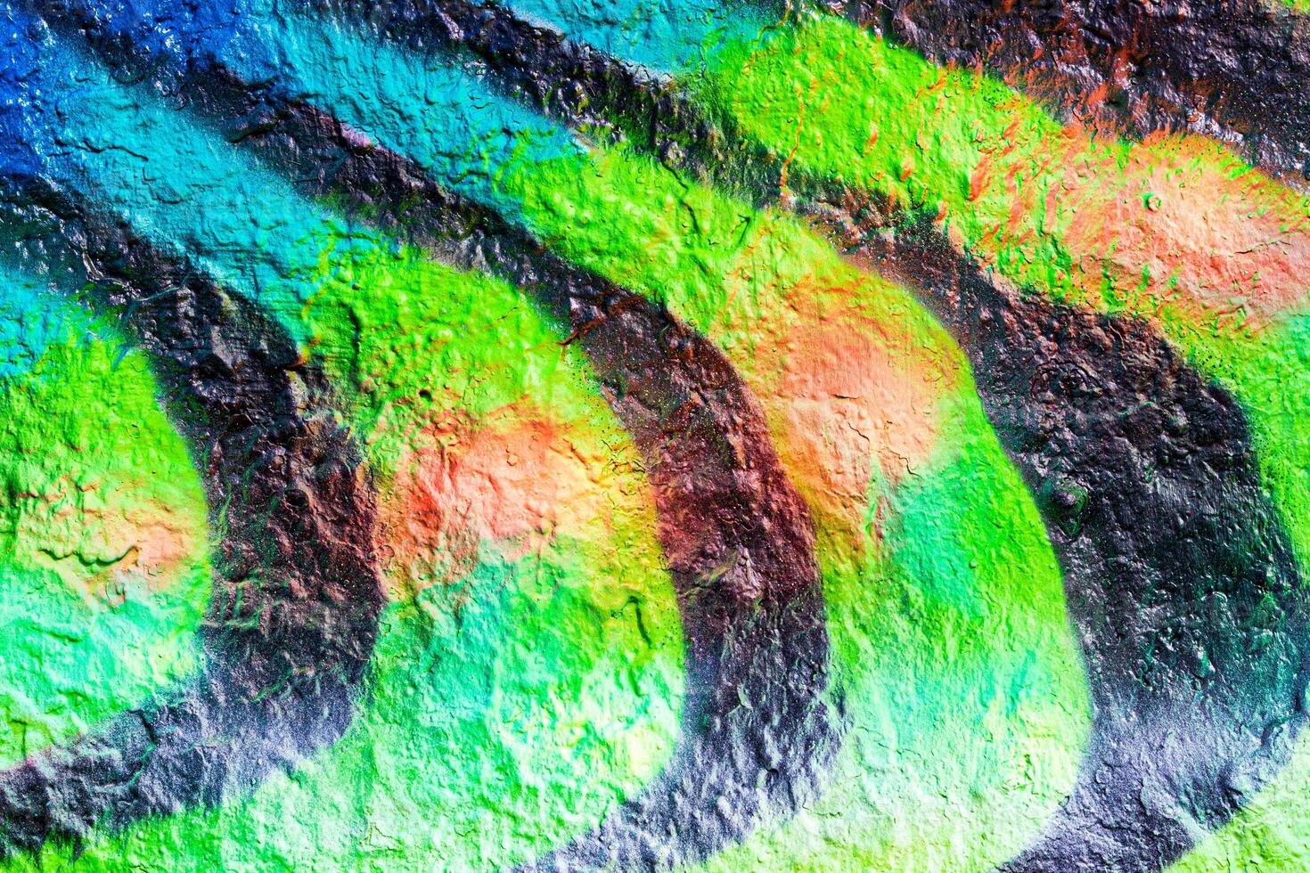 A fragment of colorful graffiti painted on a concrete wall. Abstract urban backdrop for design. photo