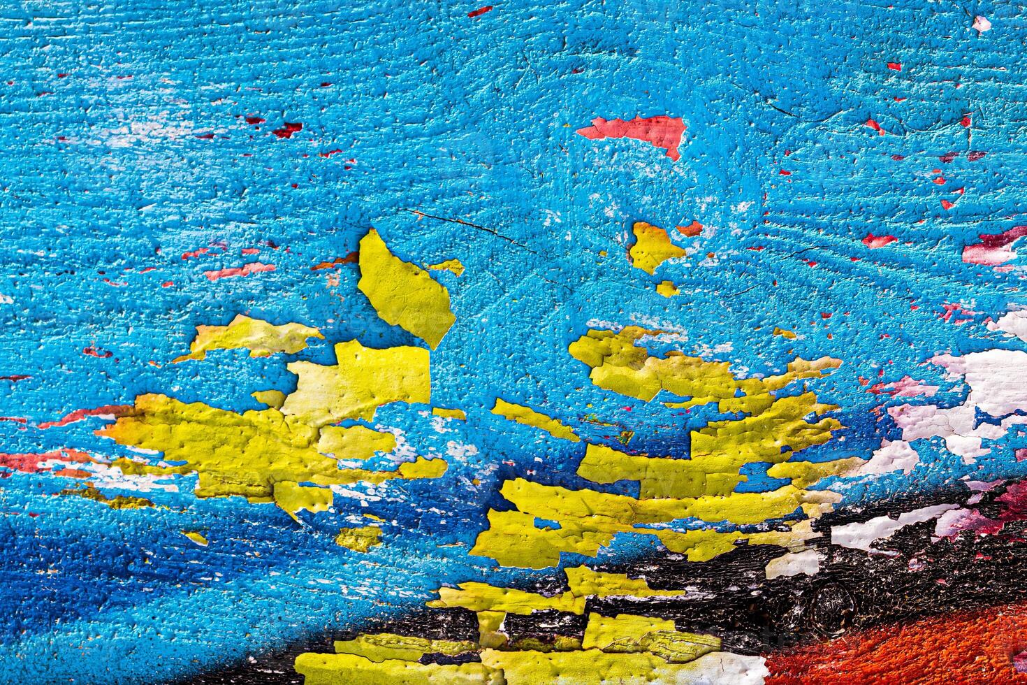 A fragment of colorful graffiti painted on a wooden board with peeling paint close-up. Abstract backdrop for design. photo