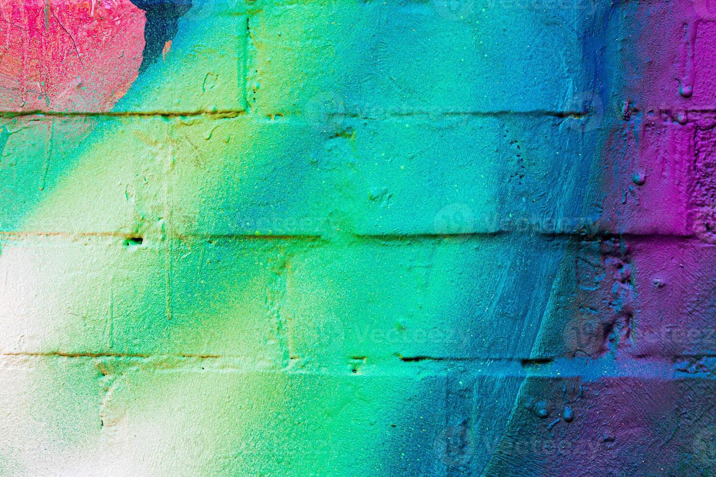 A fragment of colorful graffiti painted on a brick wall. Abstract backdrop for design. photo