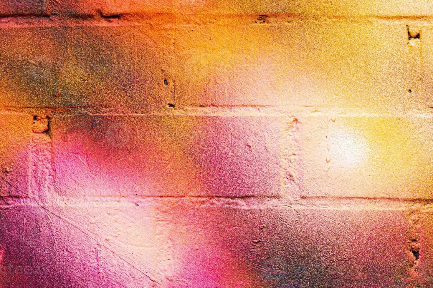 A fragment of colorful graffiti painted on a brick wall. Abstract backdrop for design. photo