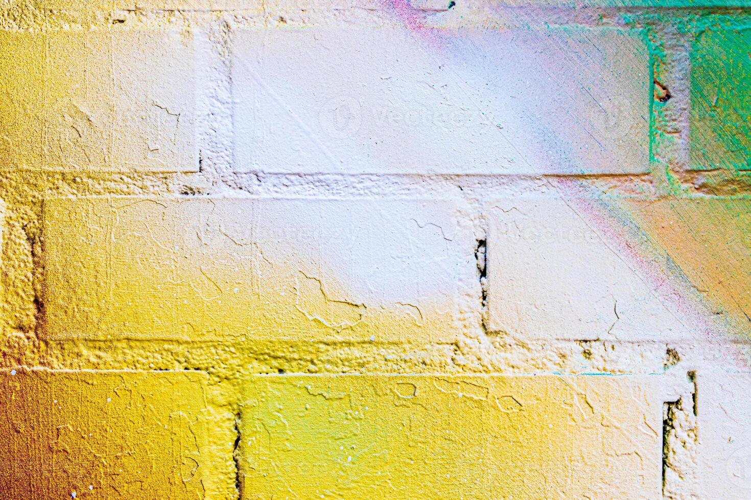 A fragment of colorful graffiti painted on a brick wall. Abstract backdrop for design. photo
