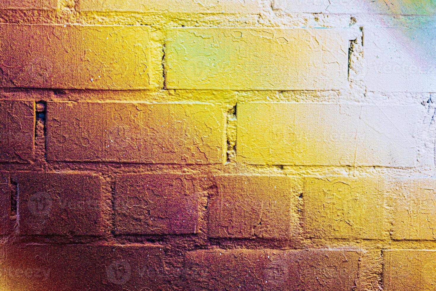 A fragment of colorful graffiti painted on a brick wall. Abstract backdrop for design. photo