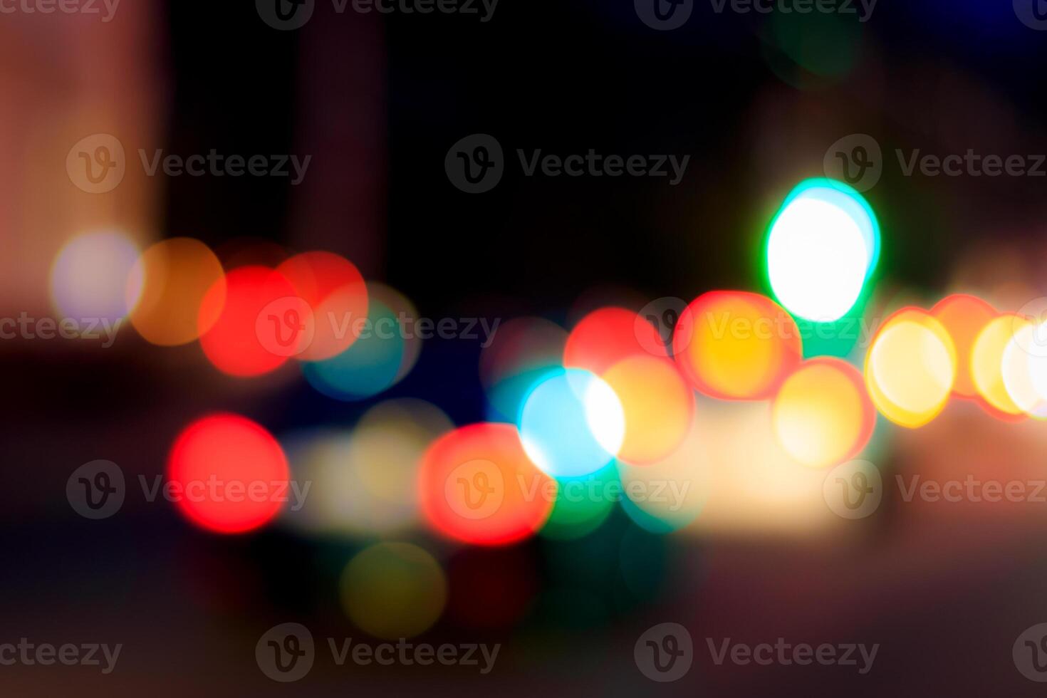 Blurred lights of headlights of cars and lanterns in the night city. Abstract bokeh. photo