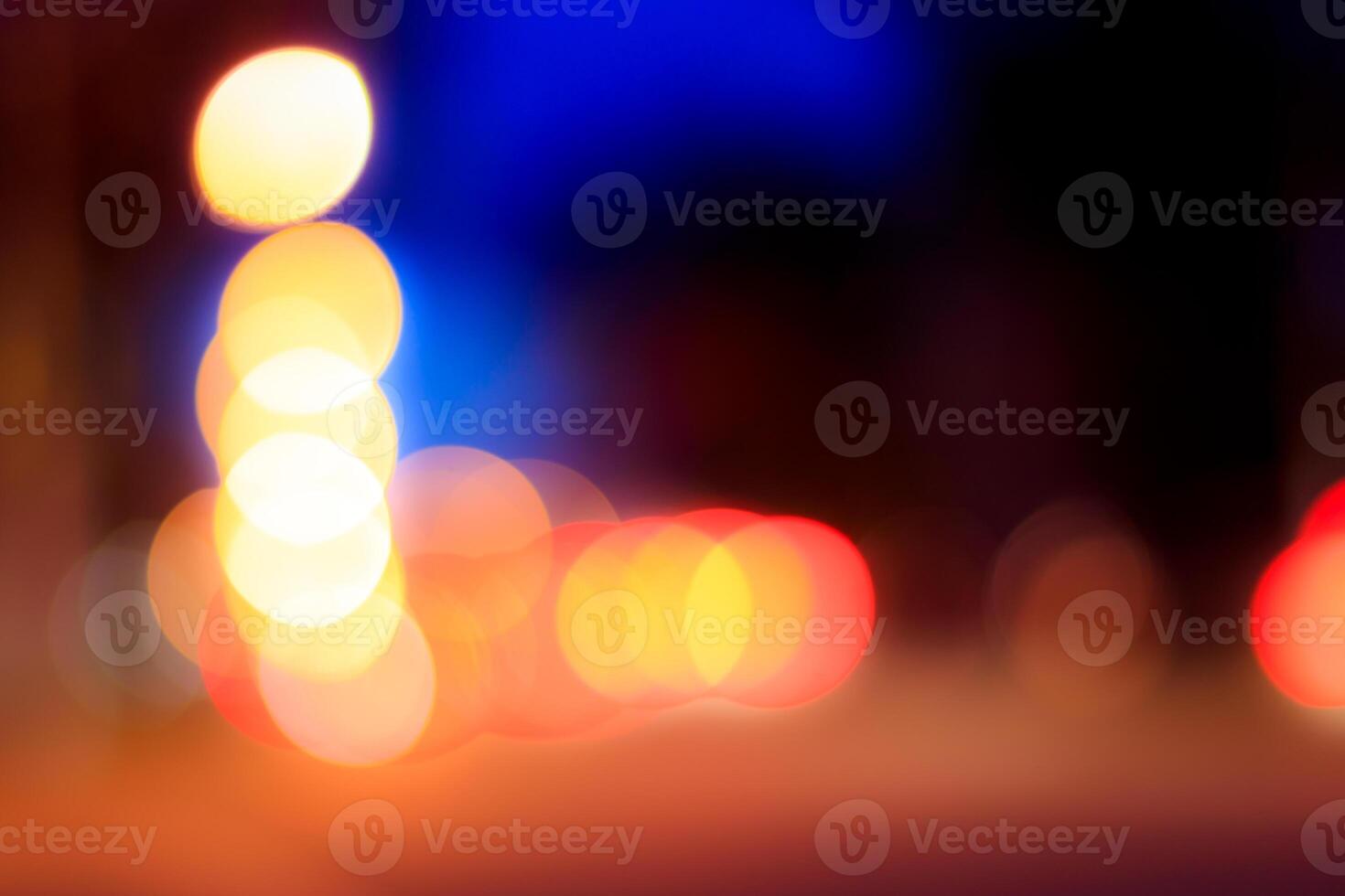 Blurred lights of headlights of cars and lanterns in the night city. Abstract bokeh. photo
