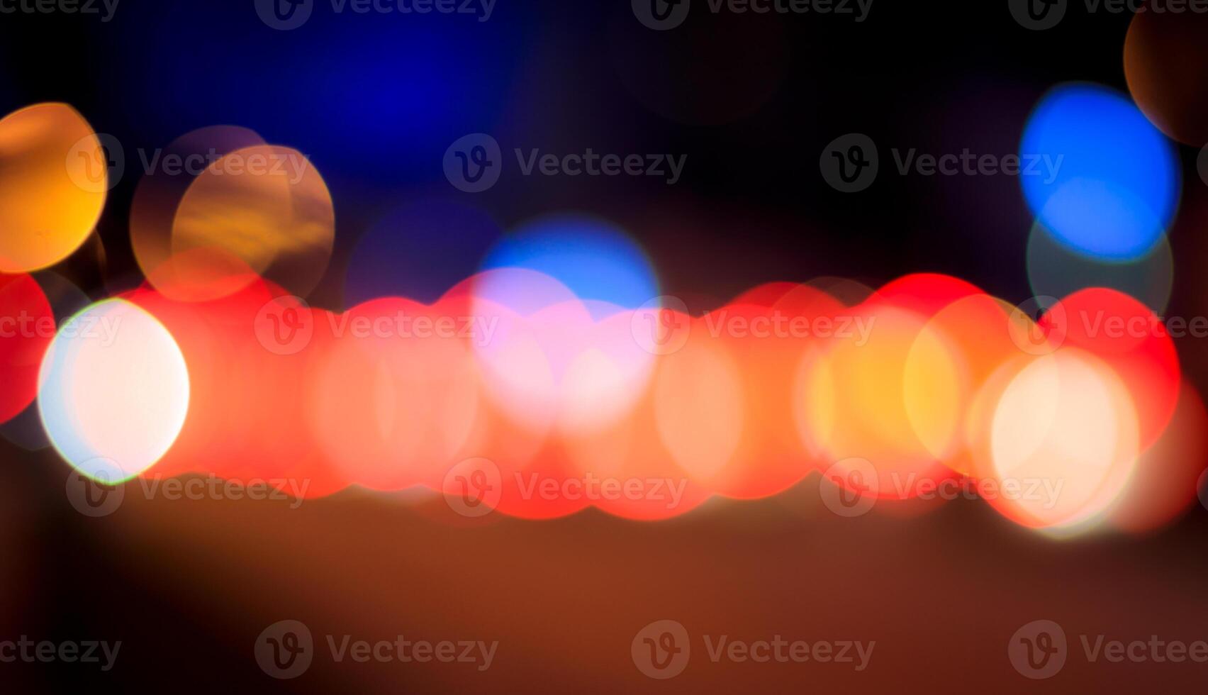 Blurred lights of headlights of cars and lanterns in the night city. Abstract bokeh. photo