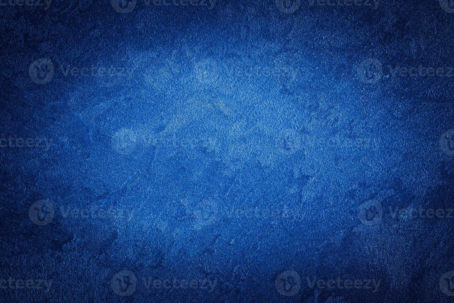 Blue decorative plaster texture with vignette. Abstract grunge background with copy space. photo