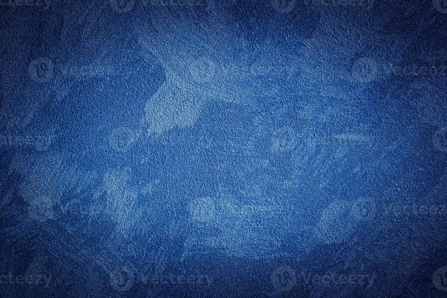 Blue decorative plaster texture with vignette. Abstract grunge background with copy space. photo