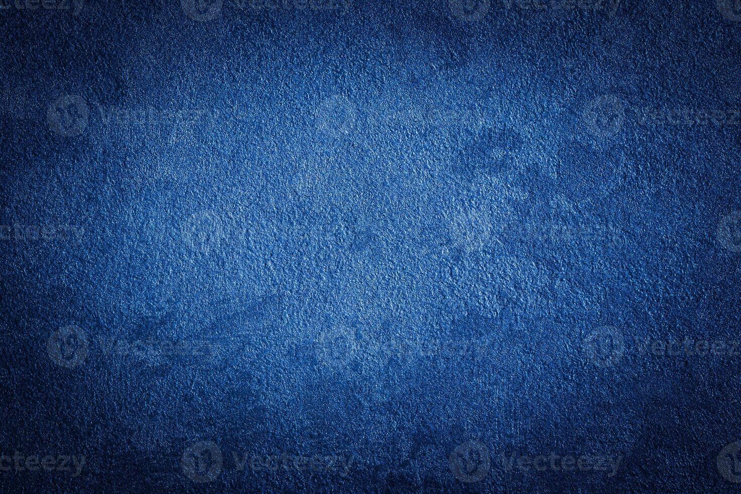 Blue decorative plaster texture with vignette. Abstract grunge background with copy space. photo