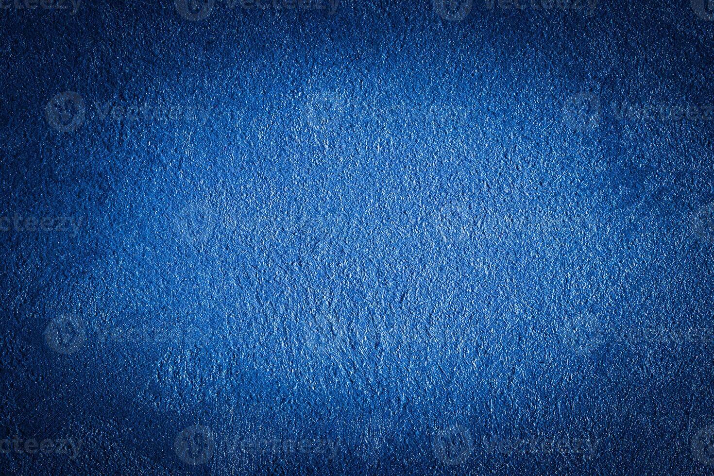 Blue decorative plaster texture with vignette. Abstract grunge background with copy space. photo
