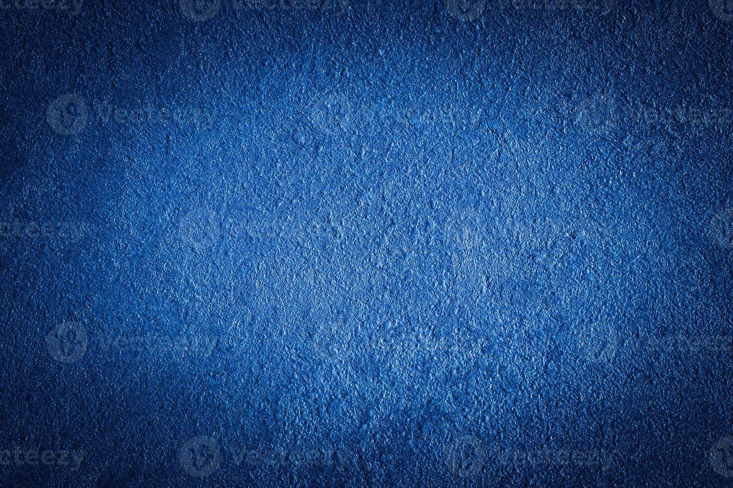 Blue decorative plaster texture with vignette. Abstract grunge background with copy space. photo