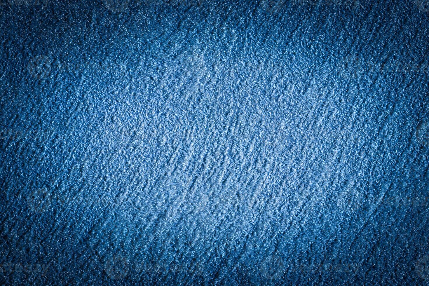 Blue decorative plaster texture with vignette. Abstract grunge background with copy space. photo