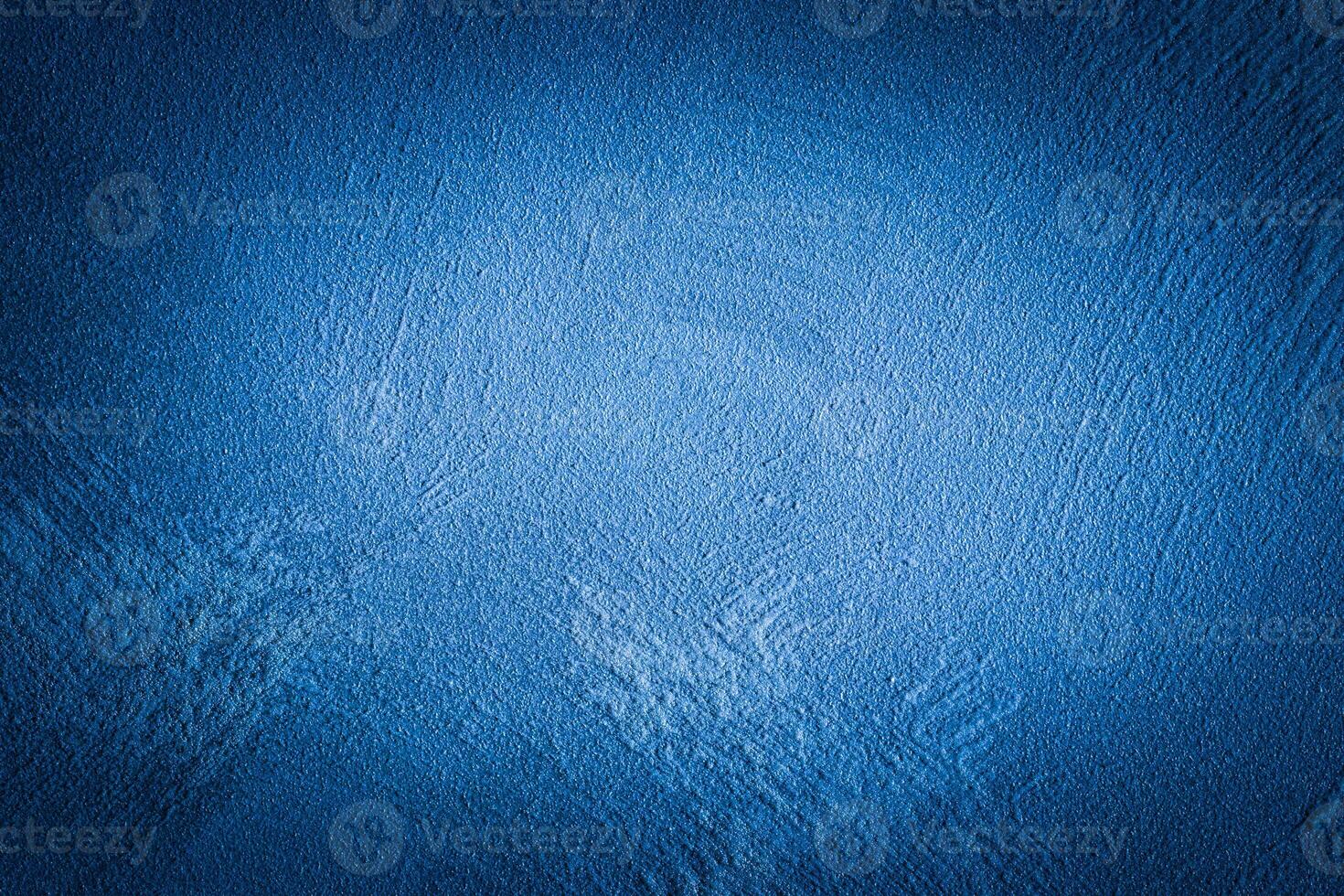 Blue decorative plaster texture with vignette. Abstract grunge background with copy space. photo