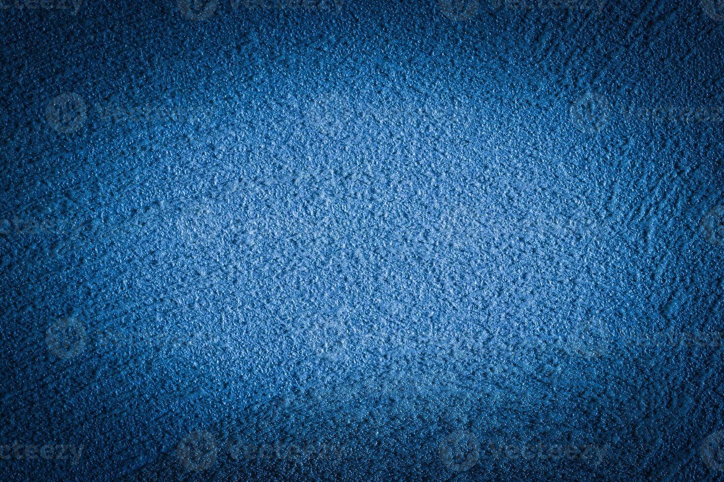 Blue decorative plaster texture with vignette. Abstract grunge background with copy space. photo