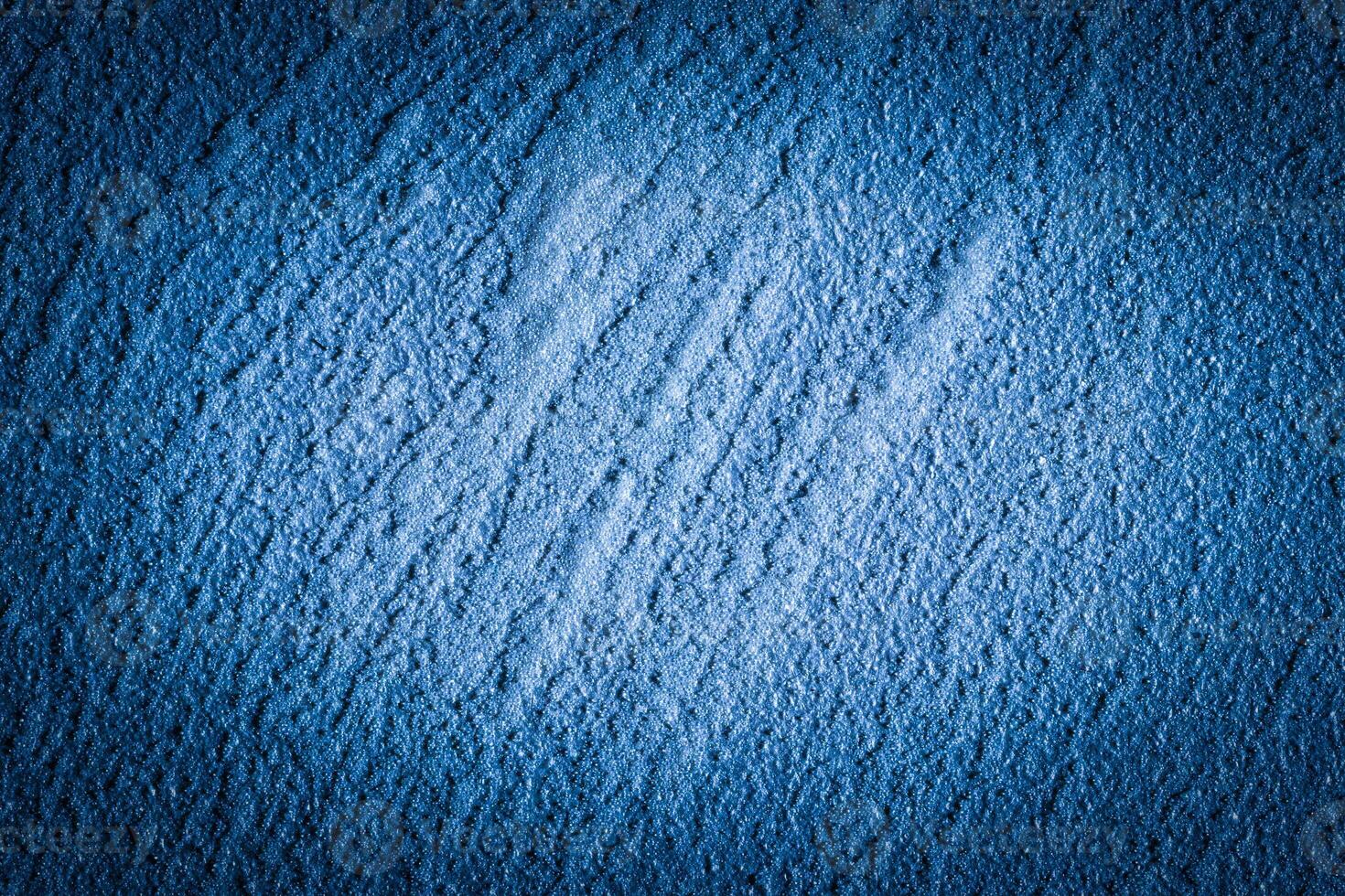 Blue decorative plaster texture with vignette. Abstract grunge background with copy space. photo