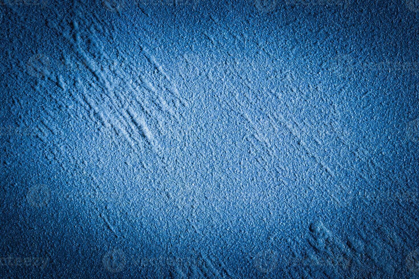 Blue decorative plaster texture with vignette. Abstract grunge background with copy space. photo