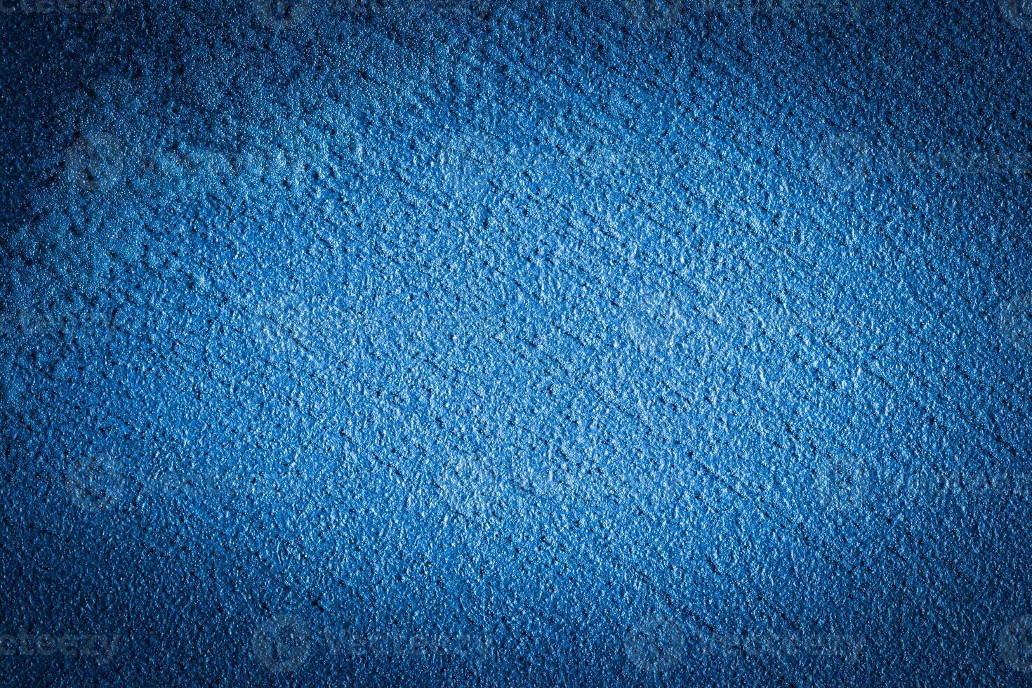 Blue decorative plaster texture with vignette. Abstract grunge background with copy space. photo