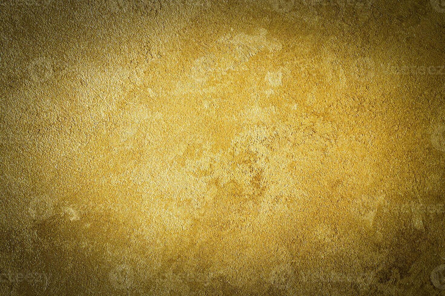 Golden decorative plaster texture with vignette. Abstract grunge background with copy space. photo