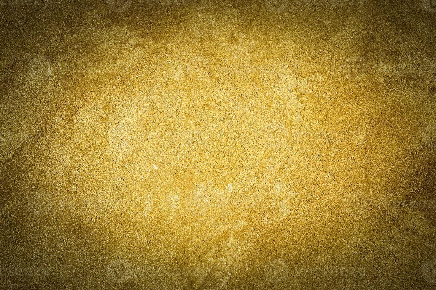 Golden decorative plaster texture with vignette. Abstract grunge background with copy space. photo