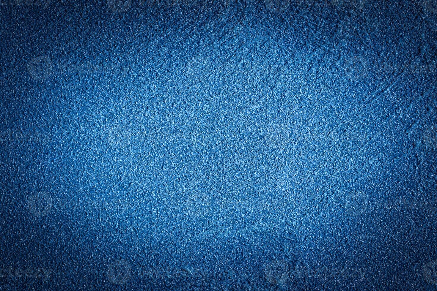 Blue decorative plaster texture with vignette. Abstract grunge background with copy space. photo