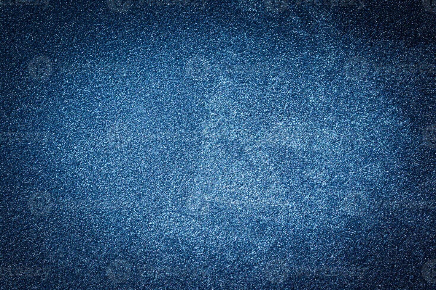 Blue decorative plaster texture with vignette. Abstract grunge background with copy space. photo