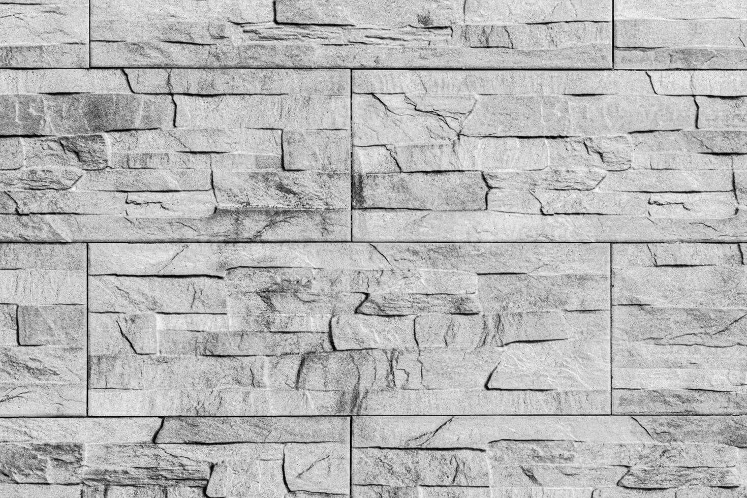 Black and white texture of a wall covered with decorative brick-like tiles. Abstract background for design. photo