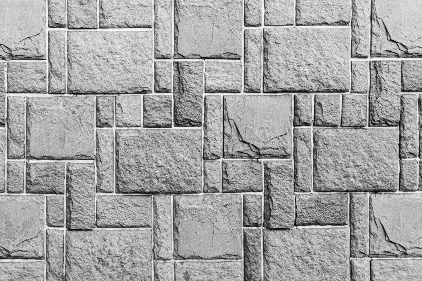 Black and white texture of a wall covered with decorative brick-like tiles. Abstract background for design. photo